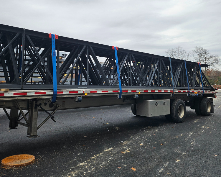 Steel beams being delivered to the New West Essex YMCA construction site